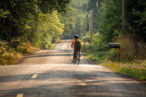 Child riding bike on rural road