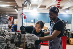 Students working on car engine